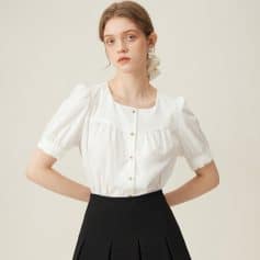 Elegant white women's blouse with stylish gold buttons, puff sleeves, and comfortable fit, perfect for professional or casual wear.