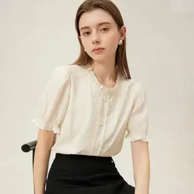 Stylish women's linen blouse with delicate embroidery, button-down front, and ruffled sleeves, perfect for casual and formal occasions.