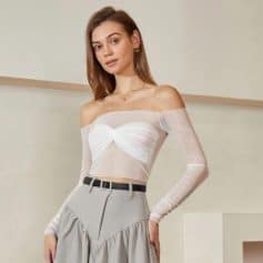 Stunning off-shoulder sheer dress featuring a twisted front design, paired with a high-waisted gray skirt, ideal for women seeking chic and modern fashion at Monalisa Store.