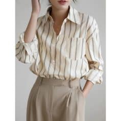 A stylish beige and black striped blouse perfect for medical staff or casual wear, combining comfort and professional appearance.