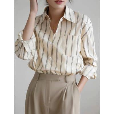 A stylish beige and black striped blouse perfect for medical staff or casual wear, combining comfort and professional appearance.