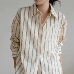 Stylish women's striped button-up shirt with a front pocket, perfect for casual and office wear, offering comfort and elegance.