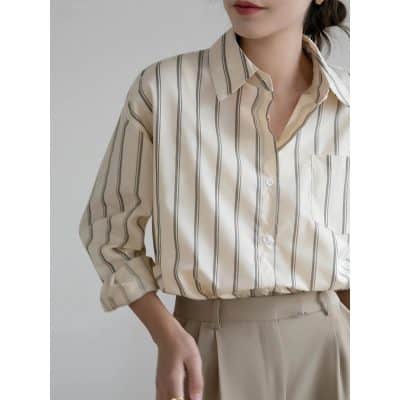 Elegant women's striped blouse ideal for office or casual wear, featuring a classic collar, button-up front, and comfortable fit for professional or everyday fashion.