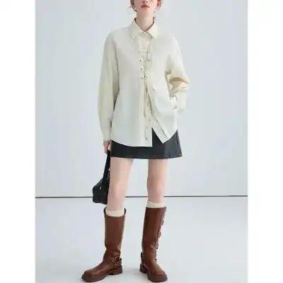 Elegant cream-colored shirt with a lace-up front detail, oversized fit, long sleeves, and a collared neckline, perfect for casual or chic outings.