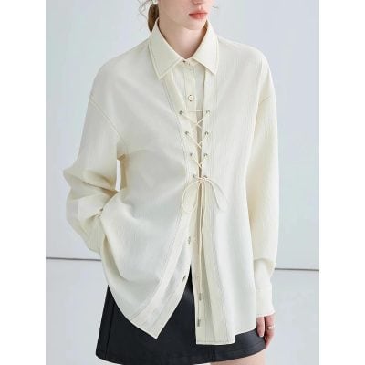 Elegant cream long-sleeve blouse with lace-up closure, perfect for stylish women seeking fashionable, comfortable clothing options.
