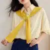 Light yellow and white striped women's shirt paired with a stylish yellow scarf tied around the neck. Perfect for casual or business casual look, versatile and trendy.