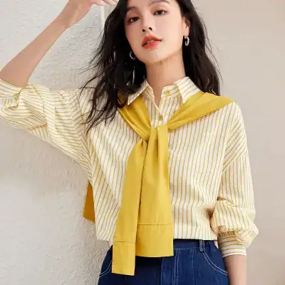 Stylish yellow and white striped blouse with a yellow necktie, perfect for fashionable women seeking trendy optical store apparel.