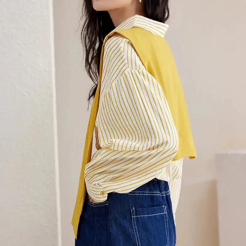 Elegant yellow and white striped blouse with long sleeves, stylish design perfect for casual or professional wear.
