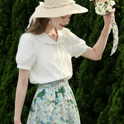 Stylish wide-brimmed straw hat with decorative ribbon adds charm to summer outfits.