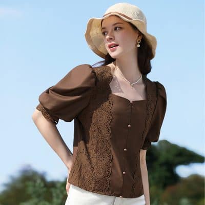 Smart casual brown blouse with puffed sleeves, lace accents, and pearl buttons, perfect for sunny days and outdoor events.