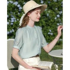 Chic summer fashion for women featuring a wide-brim hat, pastel blouse, and elegant jewelry perfect for outdoor activities and stylish leisure.
