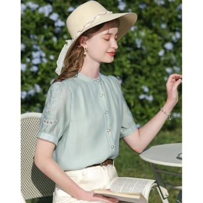Chic summer fashion for women featuring a wide-brim hat, pastel blouse, and elegant jewelry perfect for outdoor activities and stylish leisure.