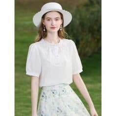 Young woman wearing stylish white summer dress and sun hat, perfect for outdoor holidays or casual outings. Emphasizes fashionable and comfortable clothing for women.