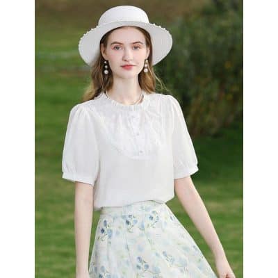 Young woman wearing stylish white summer dress and sun hat, perfect for outdoor holidays or casual outings. Emphasizes fashionable and comfortable clothing for women.
