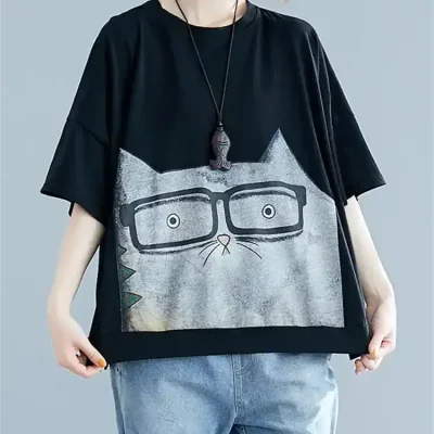Stylish women's T-shirt featuring a playful cat face graphic with glasses, perfect for casual wear. Made from soft fabric, available at Monalisa Medical Store for trendy, comfortable fashion.