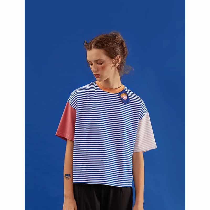 Colorful striped casual T-shirt with mixed pastel and navy hues, perfect for everyday fashion.
