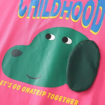 Bright pink background with a cute green cartoon face, playful design, ideal for kids' products and children's merchandise.