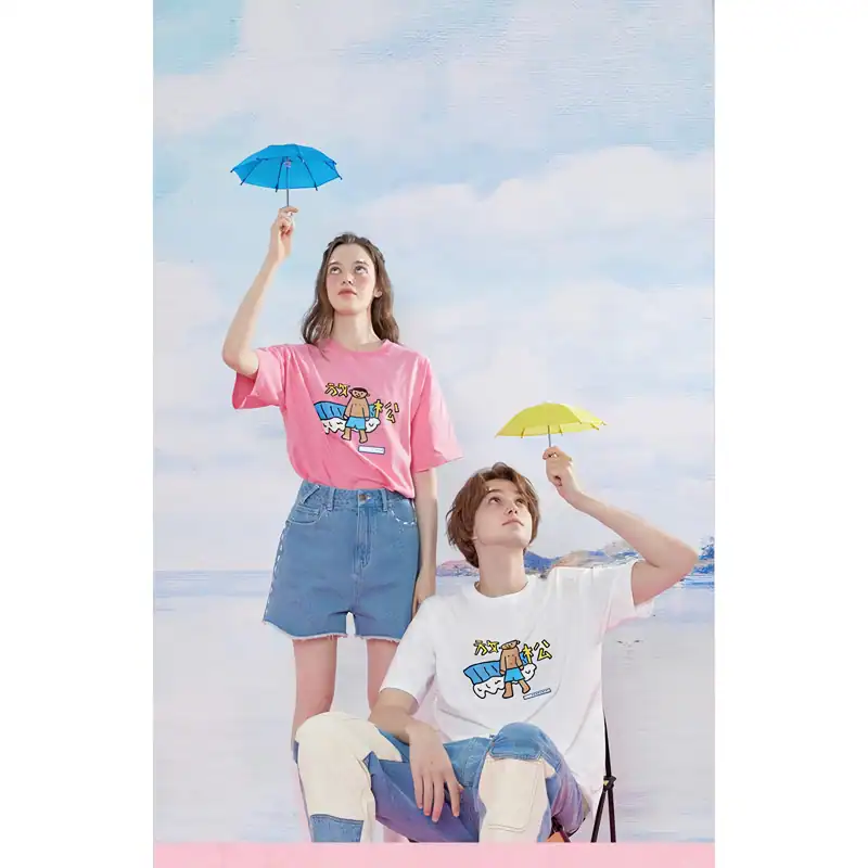 Bright young models holding umbrellas at the beach showcasing trendy casual clothing and accessories for summer style.