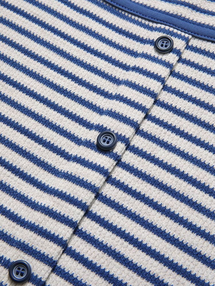Comfortable blue and white striped knit cardigan with buttons for versatile style. Perfect for casual wear and layering. Made with soft, warm fabric for everyday comfort.