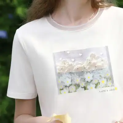 Image of a white casual T-shirt featuring a scenic floral and sky graphic, emphasizing comfort and style for women.
