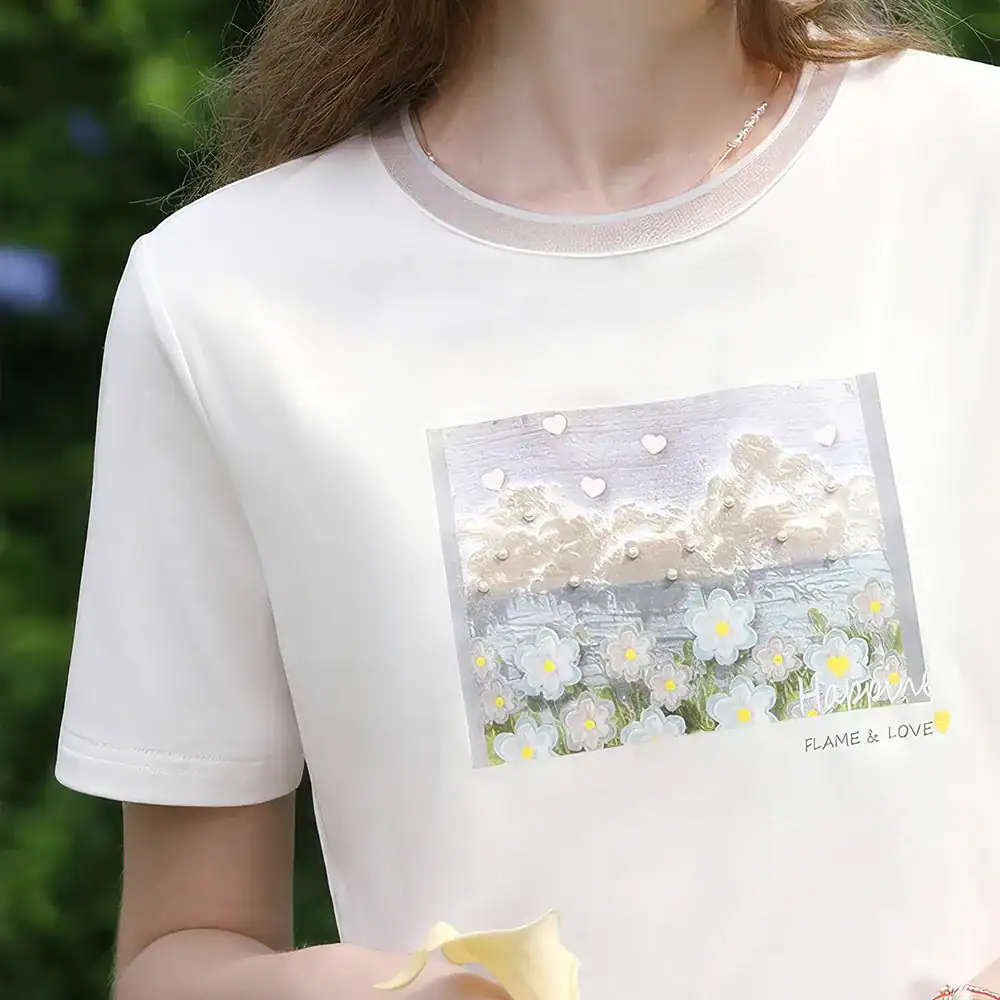 Image of a white casual T-shirt featuring a scenic floral and sky graphic, emphasizing comfort and style for women.