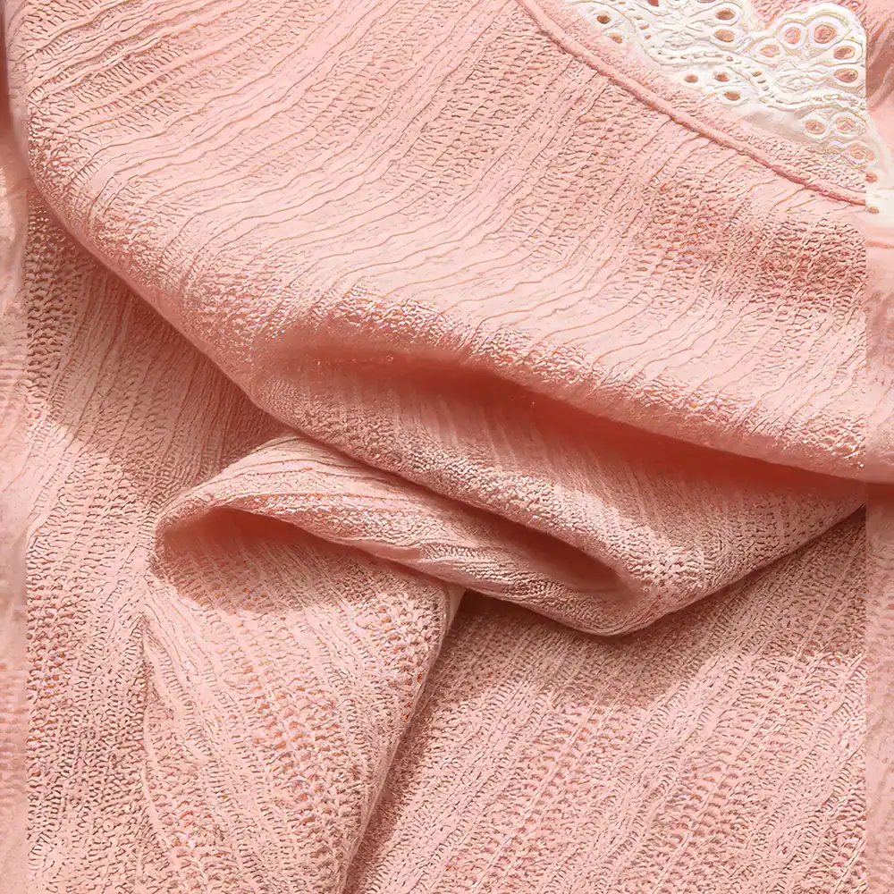 Close-up image of elegant pink lace fabric showcasing intricate patterns and fine texture, perfect for bridal wear, evening dresses, and high-end fashion garments.