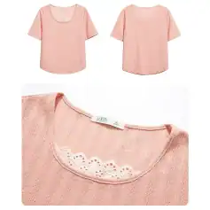 Close-up of pink women's blouse with delicate lace detail around neckline, made from lightweight, breathable fabric, perfect for casual or office wear.