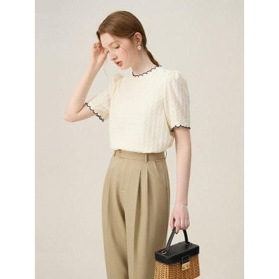 Stylish beige wide-leg trousers paired with a textured cream blouse with black trim, ideal for professional and fashionable women's clothing from Monalisa Store.
