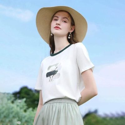 Elegant summer women's fashion with wide-brim straw hat, casual t-shirt, and light skirt, ideal for outdoor wear and sun protection, perfect for fashion-conscious women for outdoor activities or vacations.