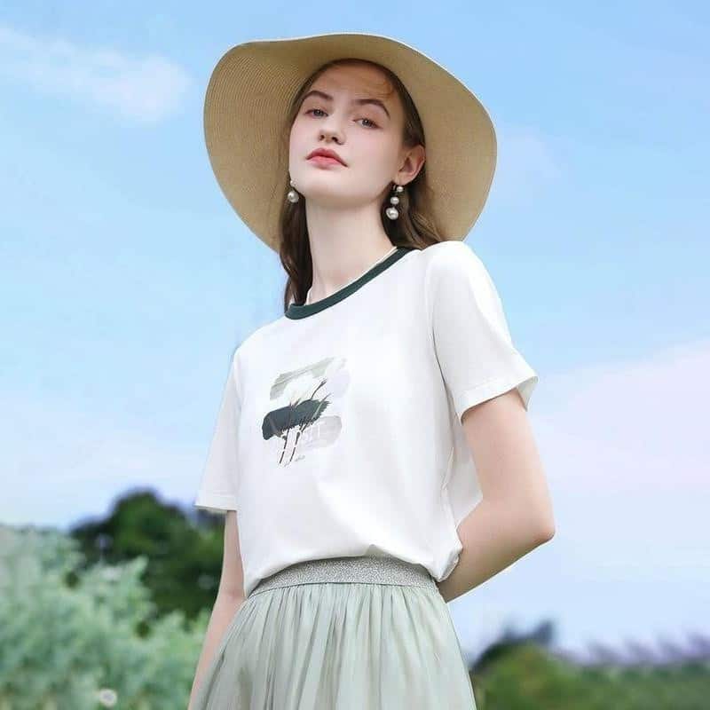 Elegant summer women's fashion with wide-brim straw hat, casual t-shirt, and light skirt, ideal for outdoor wear and sun protection, perfect for fashion-conscious women for outdoor activities or vacations.
