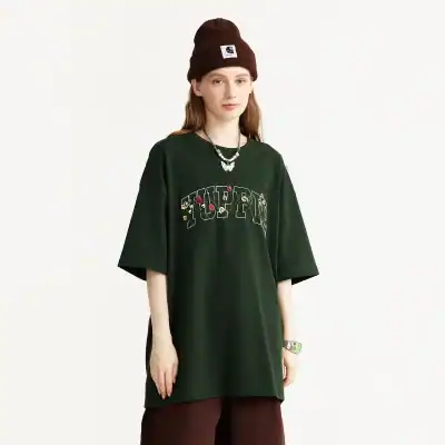 A trendy oversized black T-shirt with floral embroidery and graphic text, perfect for casual wear and street style fashion, available at Monalisa Medical Store.