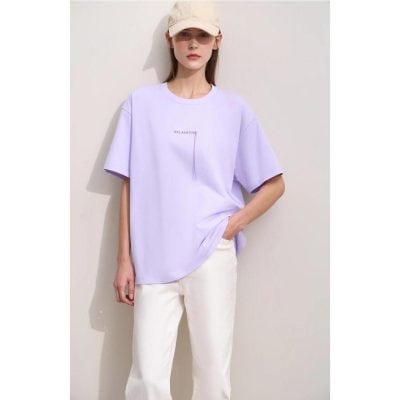Image of a stylish woman wearing a light lavender oversized T-shirt with 