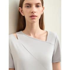 Stylish woman wearing contemporary casual top suitable for glasses and optical accessories.