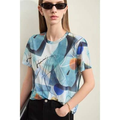 Elegant woman wearing stylish black sunglasses with contemporary abstract top, perfect for fashion-forward eyewear enthusiasts.