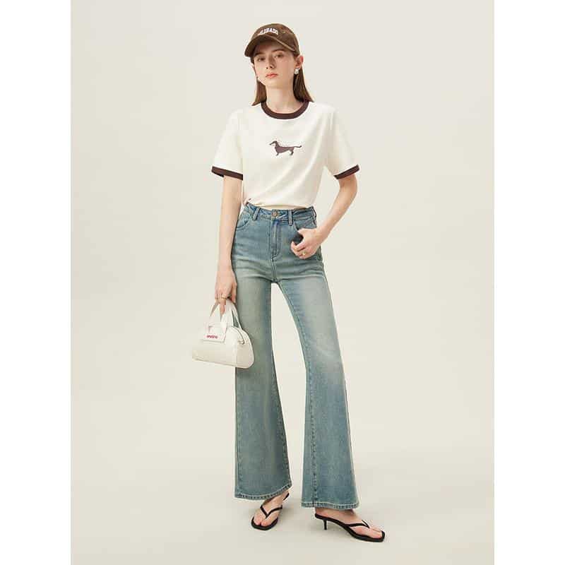 Stylish women's casual wear featuring a white graphic t-shirt, high-waisted flare jeans, and trendy accessories, perfect for modern chic looks and everyday wear.