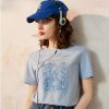 Young woman wearing a blue baseball cap and headphones, casual fashion, outdoor or studio shoot, trendy accessories, aesthetic look, natural makeup, modern style, fashion photography, lifestyle shot.