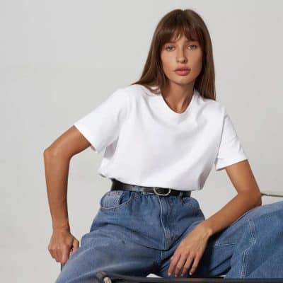 Optical fashion woman wearing casual white T-shirt and high-waisted jeans, showcasing modern style at Monalisa Store for eyewear and optical accessories.
