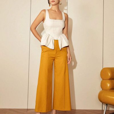 Stylish sleeveless beige top paired with mustard wide-leg trousers, perfect for professional or casual wear.
