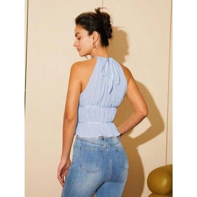 Stylish light blue sleeveless blouse for women with ruffle details, perfect for casual or semi-formal wear, ideal for enhancing your fashion statement.