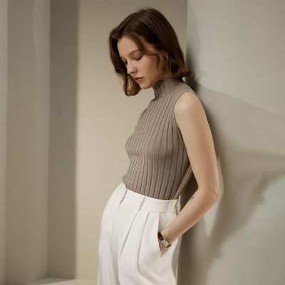 Stylish sleeveless tan ribbed turtleneck top, perfect for women seeking elegant and comfortable fashion options, ideal for casual and office wear.