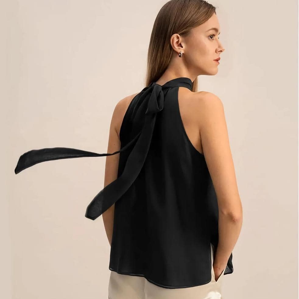 A stylish black sleeveless top featuring a tied neckline, ideal for modern women seeking versatile fashion options. Crafted from premium materials for comfort and durability, this blouse is perfect for office, casual outings, or evening events.