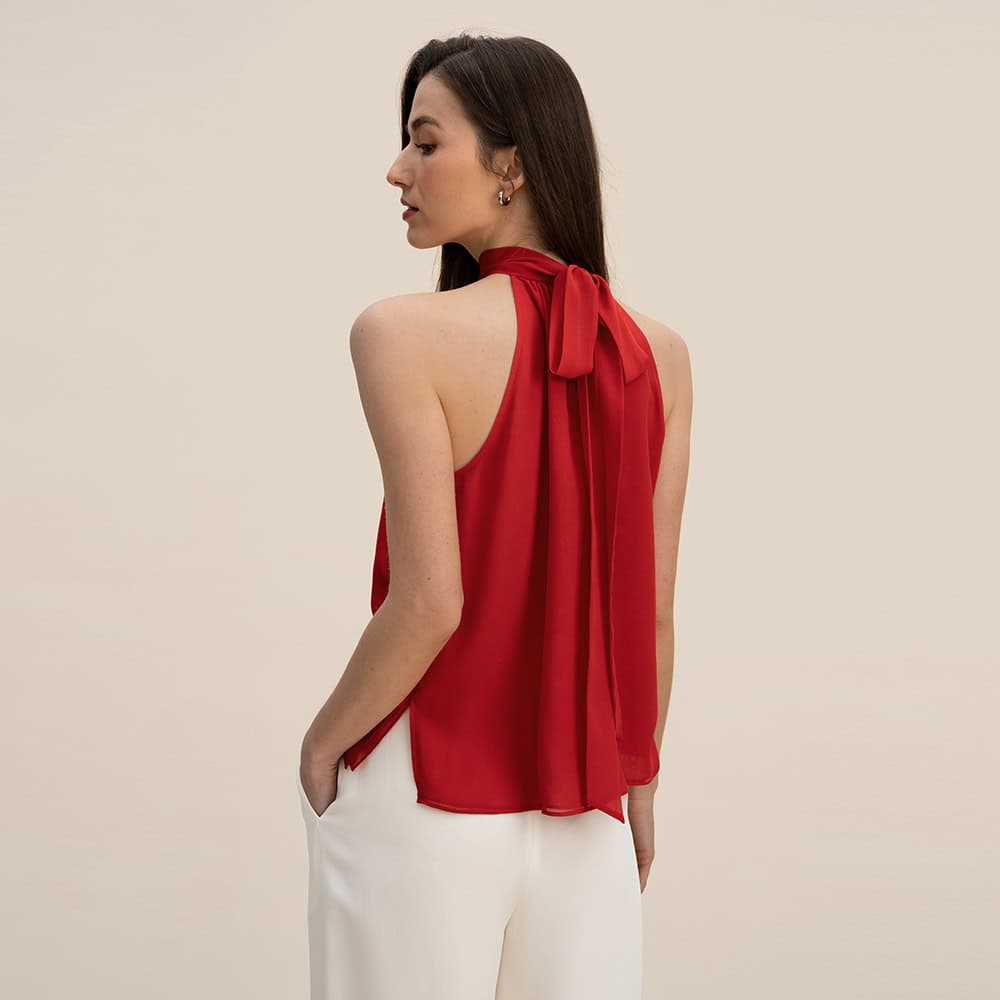 Red women's sleeveless blouse with bow-tie neckline, elegant and stylish for office or casual outings, made from lightweight, breathable fabric. Ideal for fashion-conscious women seeking sophisticated everyday wear.