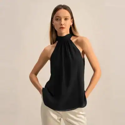 Stylish black halter top with sleeveless design, perfect for fashion-forward women seeking trendy and comfortable options. Ideal for casual or semi-formal wear.