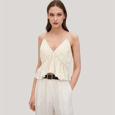 Beautiful cream-colored women's summer top with ruffled bust detail and double spaghetti straps, perfect for stylish casual or dressy occasions.