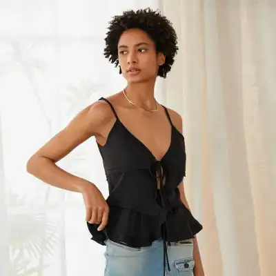 High-quality black sleeveless top with adjustable lace-up front and ruffle hem, perfect for casual and trendy looks at Monalisa Medical Store.