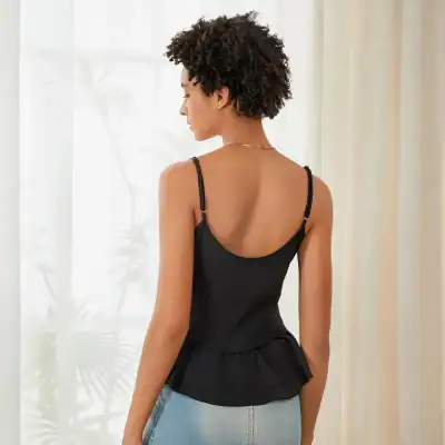 Comfortable black tank top with ruffled hem, adjustable spaghetti straps, perfect for everyday wear and stylish outfits.