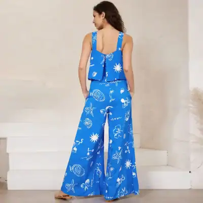 Bright blue women's summer top and matching wide-leg pants with tropical and ocean-themed prints, ideal for beach trips, resort wear, or casual summer fashion, offering comfort and style.