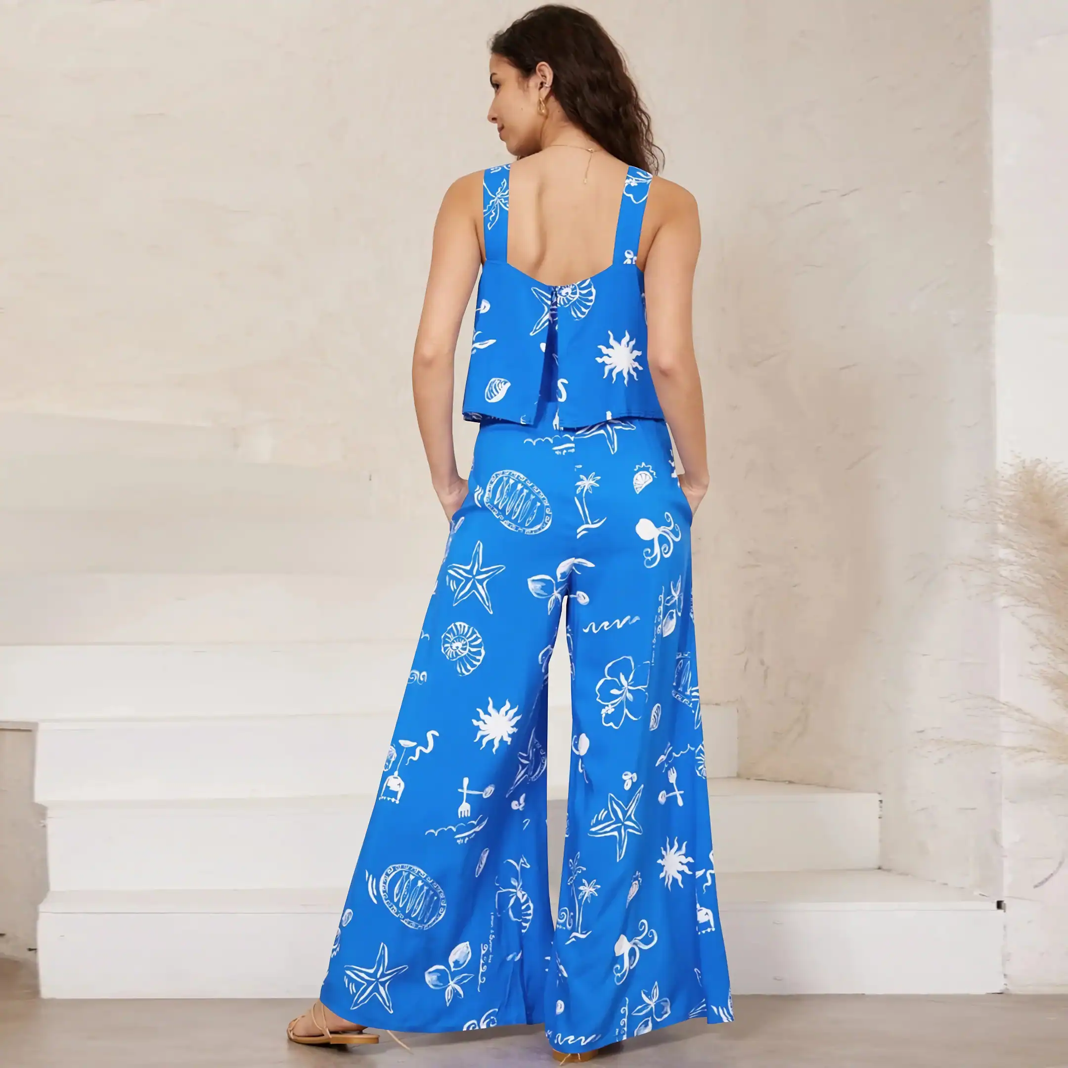 Bright blue women's summer top and matching wide-leg pants with tropical and ocean-themed prints, ideal for beach trips, resort wear, or casual summer fashion, offering comfort and style.