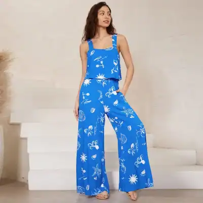 Stylish blue summer beachwear with white ocean-themed patterns, perfect for vacation or casual wear, featuring a sleeveless top and wide-leg pants for a comfortable, trendy look.