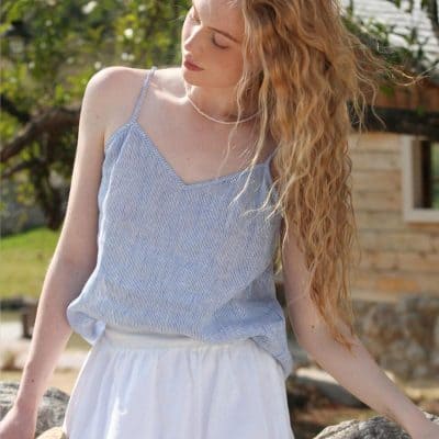 Light blue striped sleeveless top with thin straps, perfect for summer wardrobe. Stylish and breathable for warm weather.